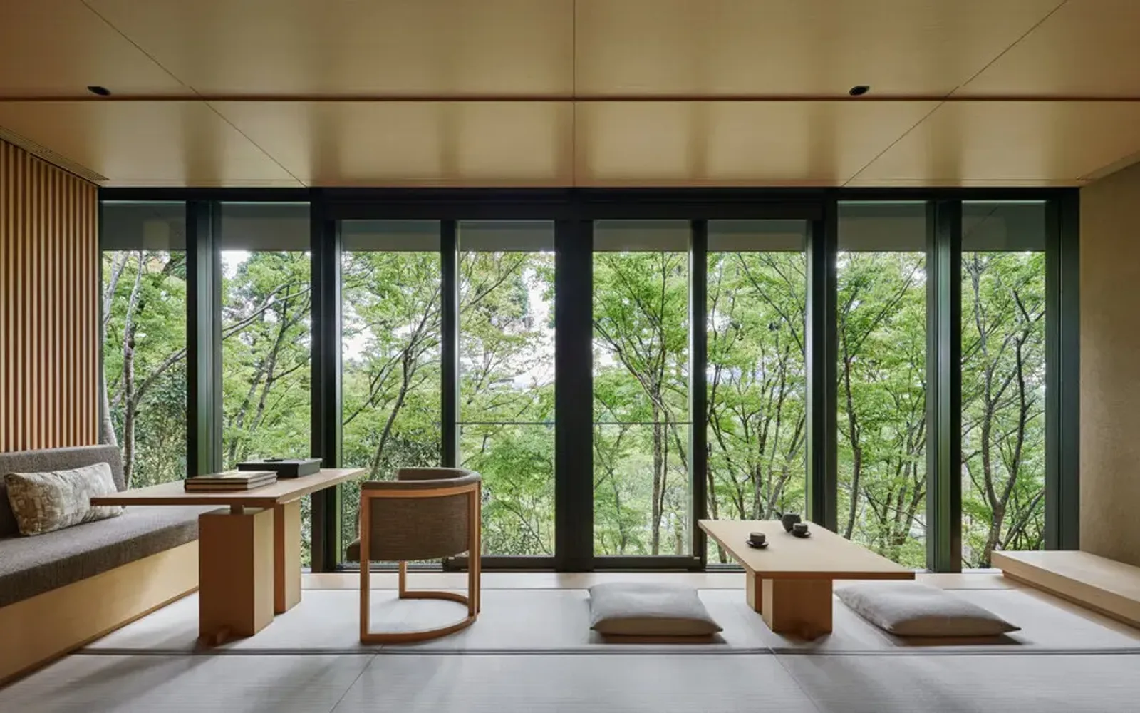 Washigamine Suite at Aman Kyoto with expansive windows framing forest views, minimalist interior and natural materials.