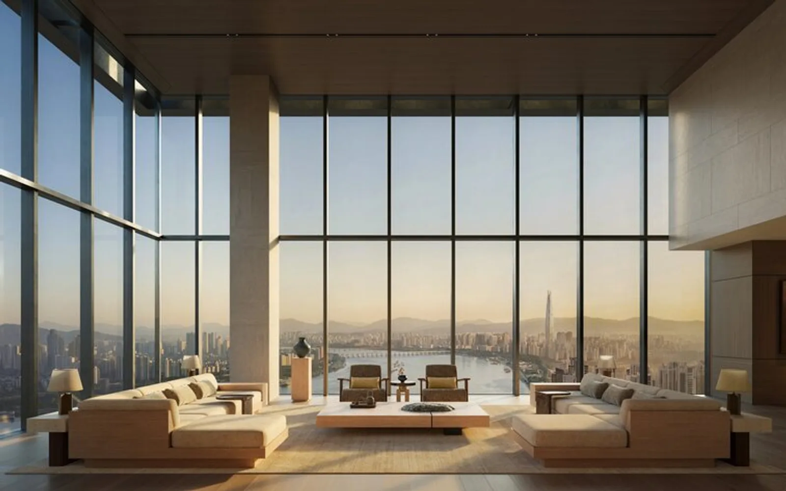 Modern living room at Aman Seoul with floor-to-ceiling windows overlooking the city skyline at dusk.