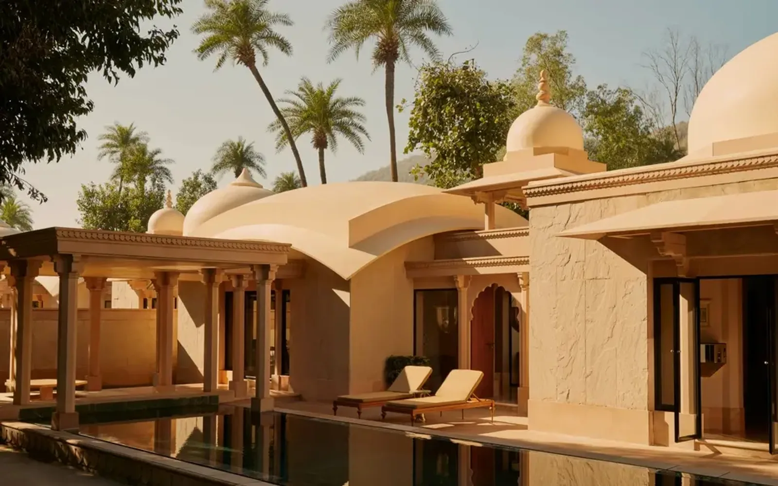 Pool pavilion at Amanbagh with terracotta walls and dome architecture overlooking the grounds.
