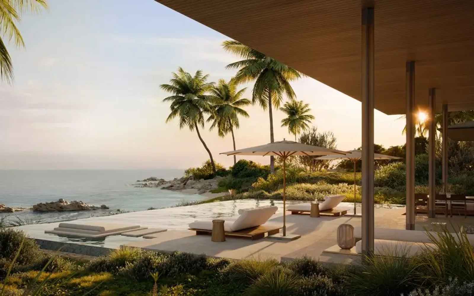 Amancaya pool terrace overlooking the Pacific coast at sunset, with palm trees and loungers.