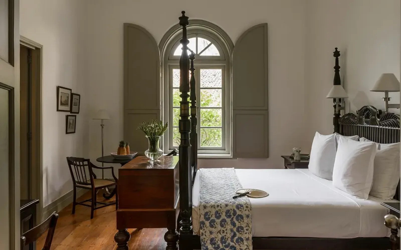 Principal bedroom at Amangalla with arched doorway and period furnishings.