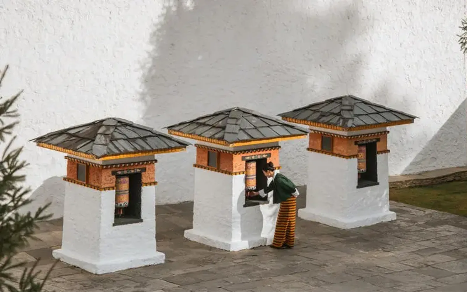 Amankora pavilions with wooden roofs and white walls in Thimphu, Bhutan.