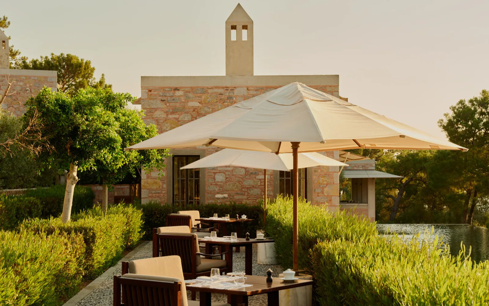 Amanruya's poolside dining terrace overlooking the Aegean landscape.