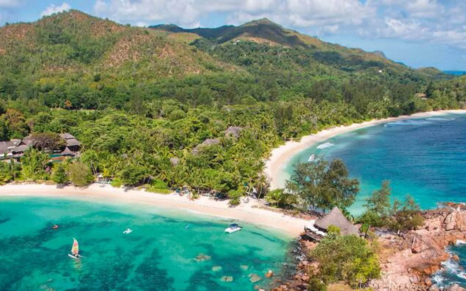 Aerial view of Constance Lemuria beside a crescent beach on Praslin.
