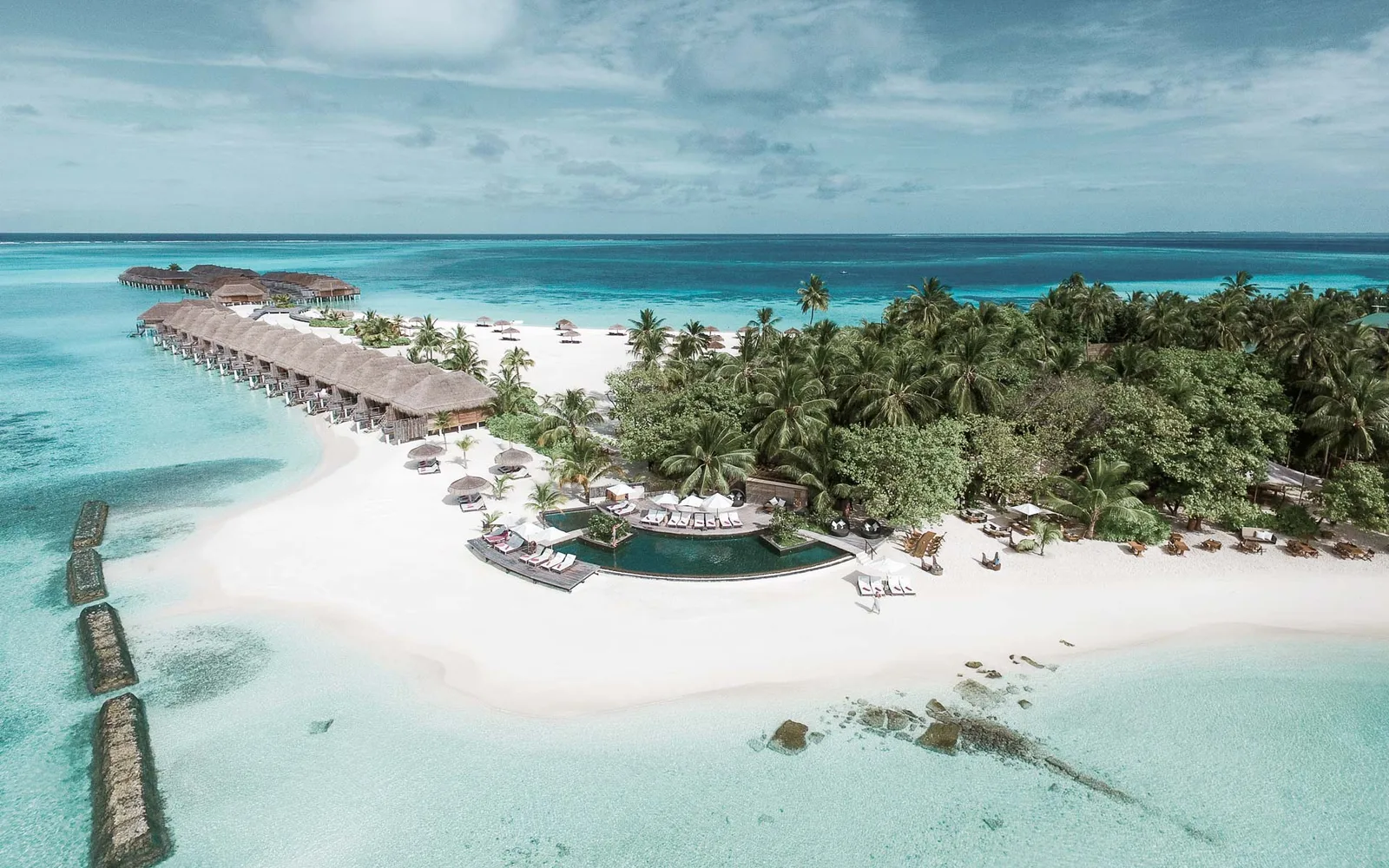 Overwater villas and the beachfront pool at Constance Moofushi.