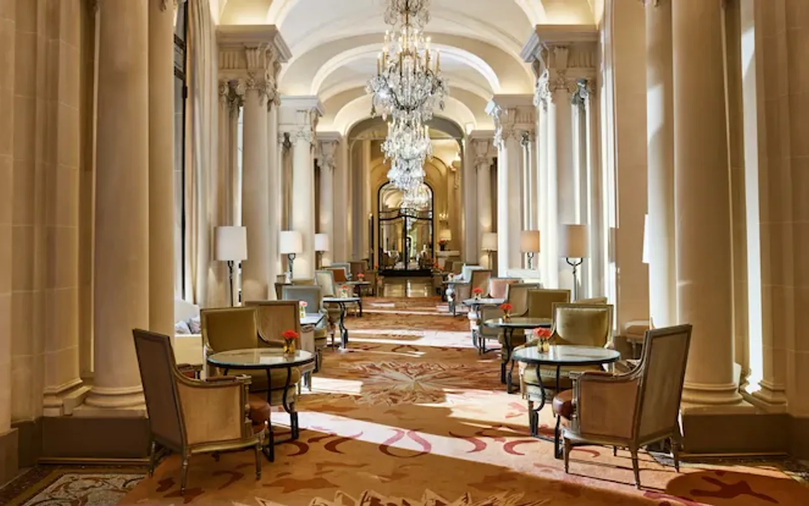 La Galerie dining room corridor with its chandeliers and set up tables, at Hotel Plaza Athénée, Paris