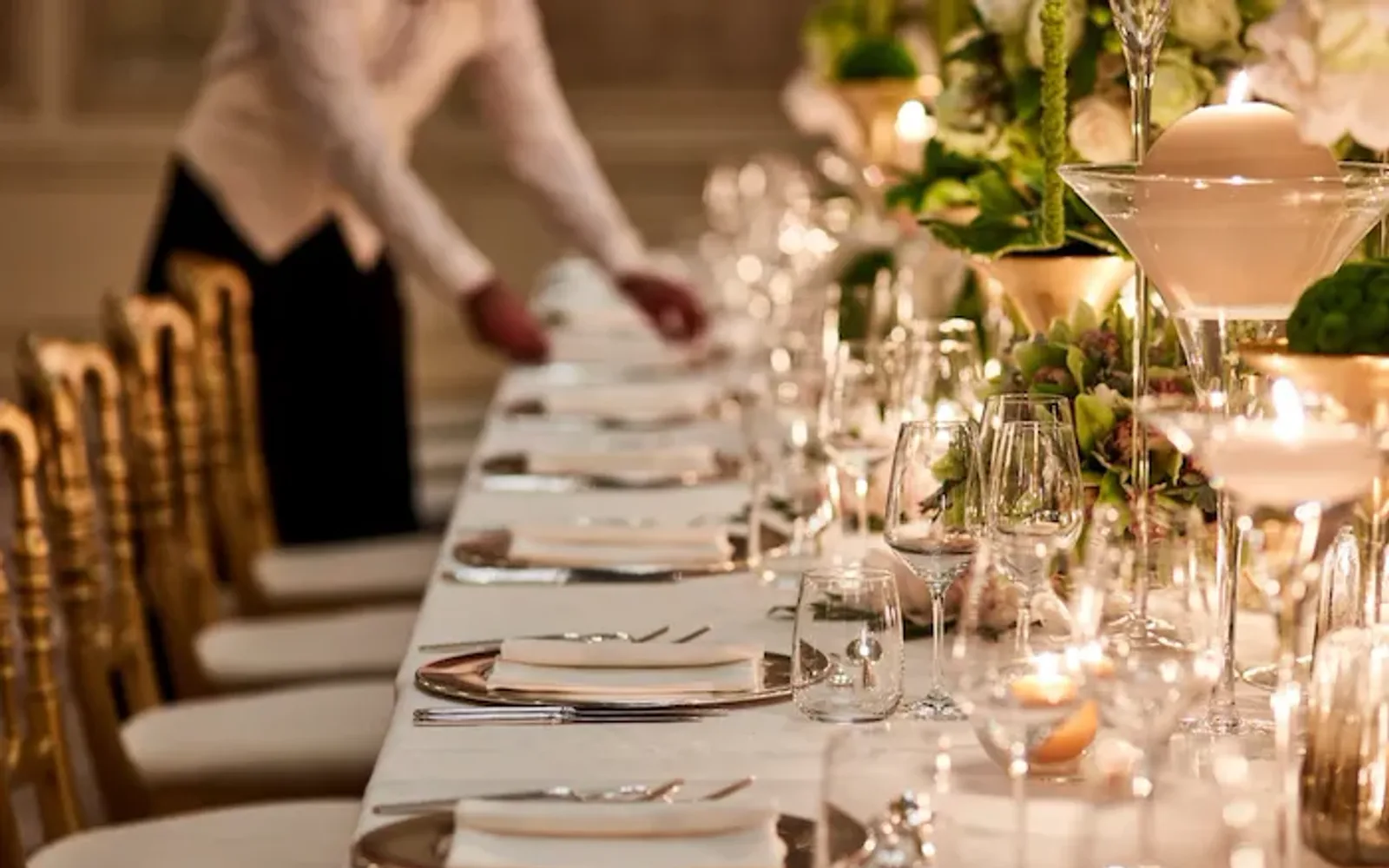 Cristalli Gala Room table set up for event with waiter arranging table at Hotel Principe Di Savoia, Milan