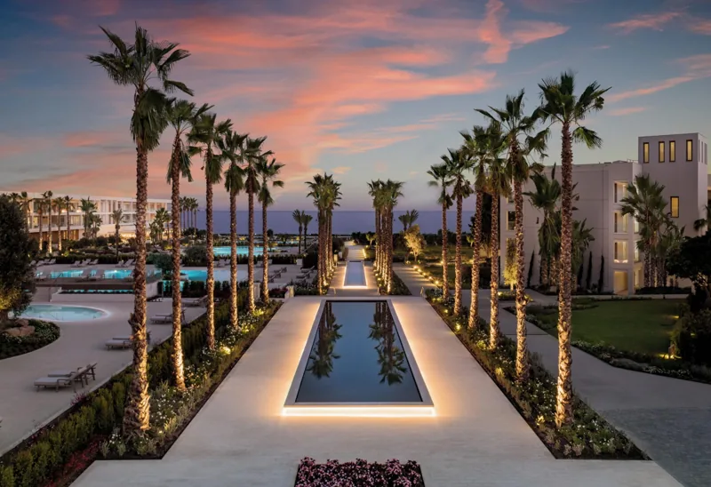 The palm-lined boulevard at Ikos Andalusia at sunset