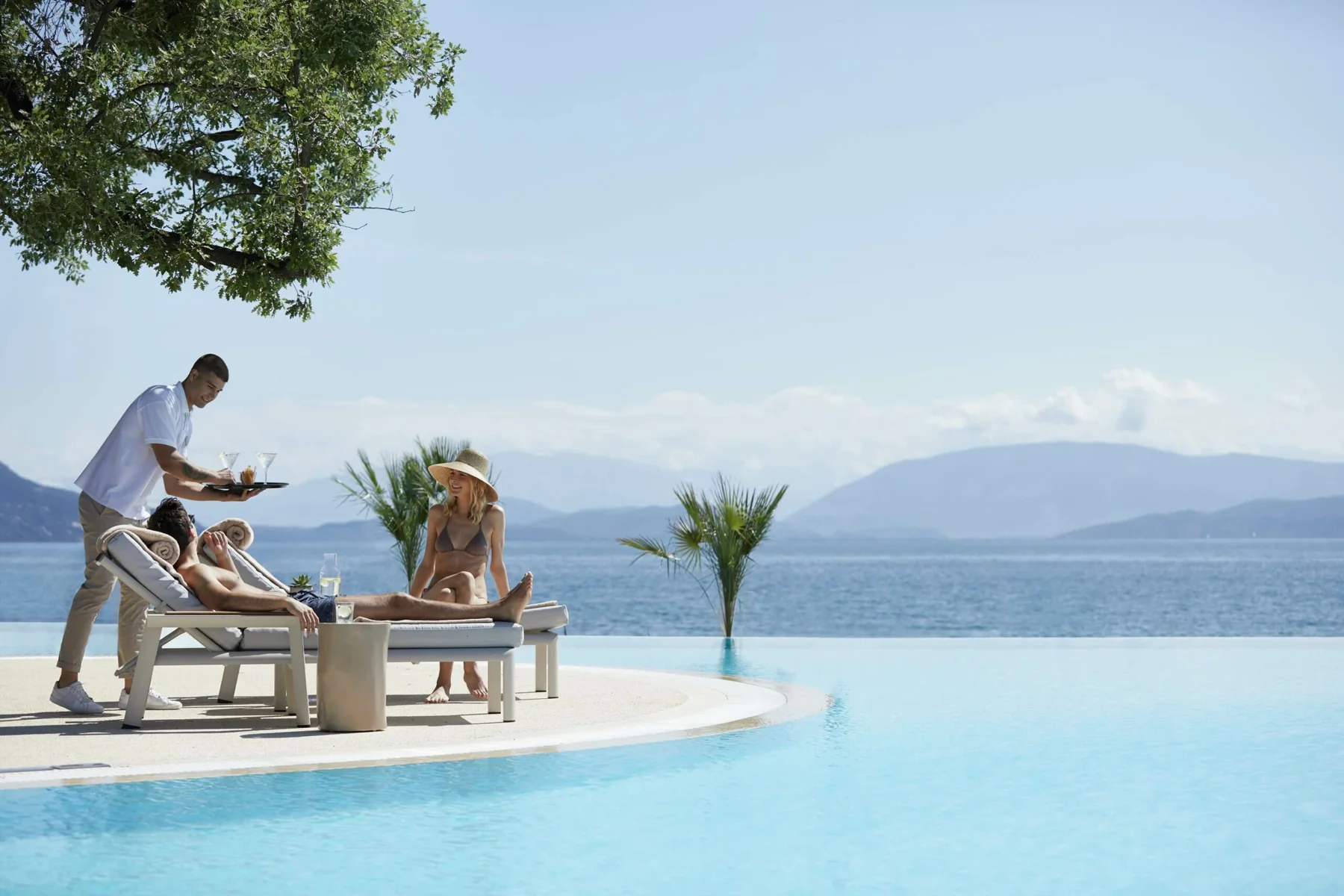 Poolside service overlooking the sea at Ikos Dassia