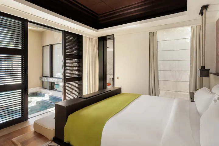 Mandarin Pool Villa bedroom beside its private pool at Mandarin Oriental, Marrakech