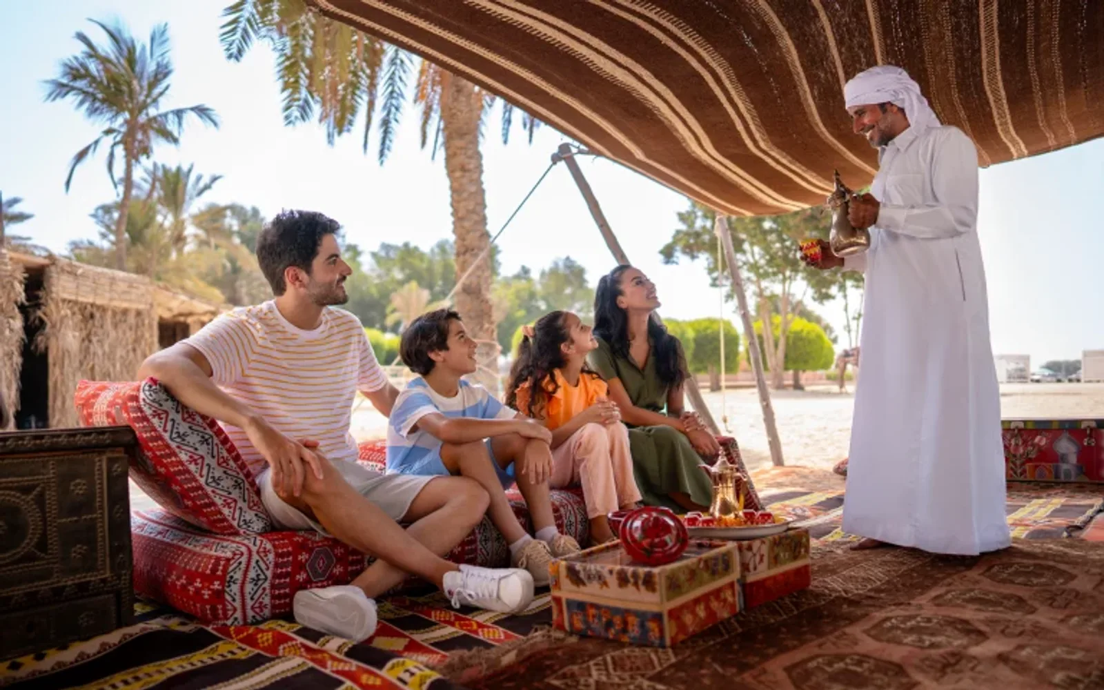 Family gathered at the Bedouin Tent for a local experience with the camel keeper