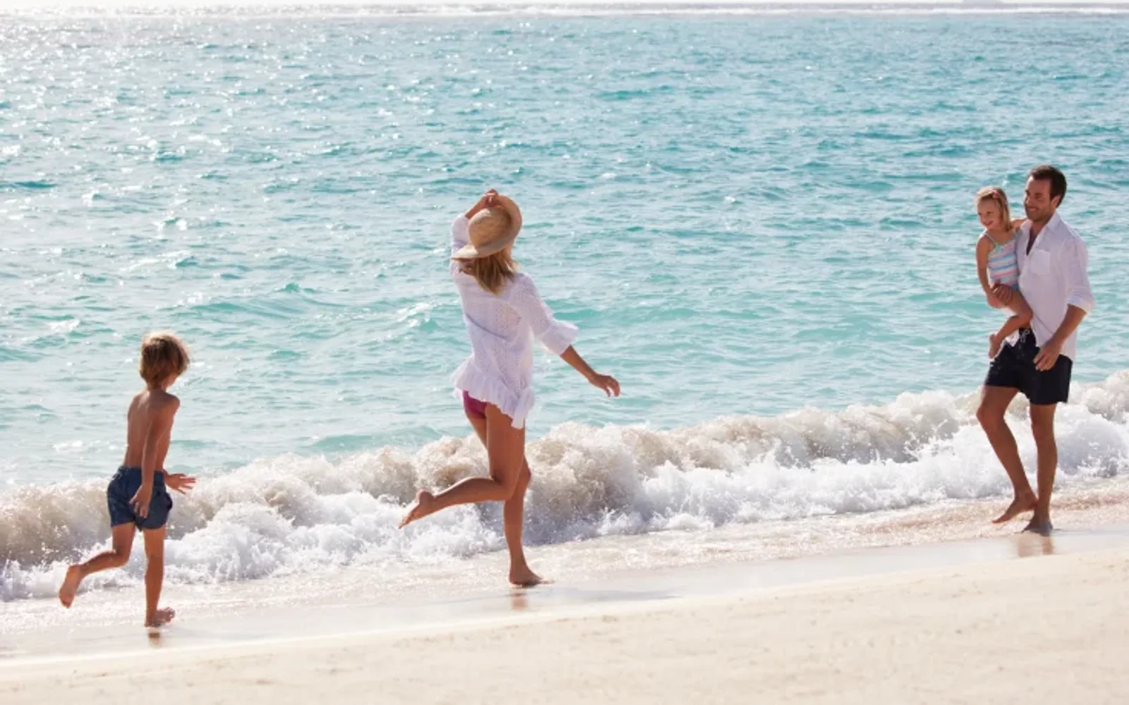 Family frolicking on the beach.