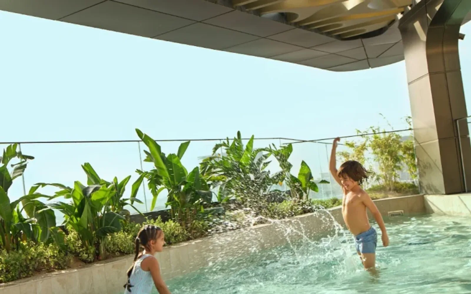 two children playing in the rooftop pool at mandarin oriental downtown, dubai