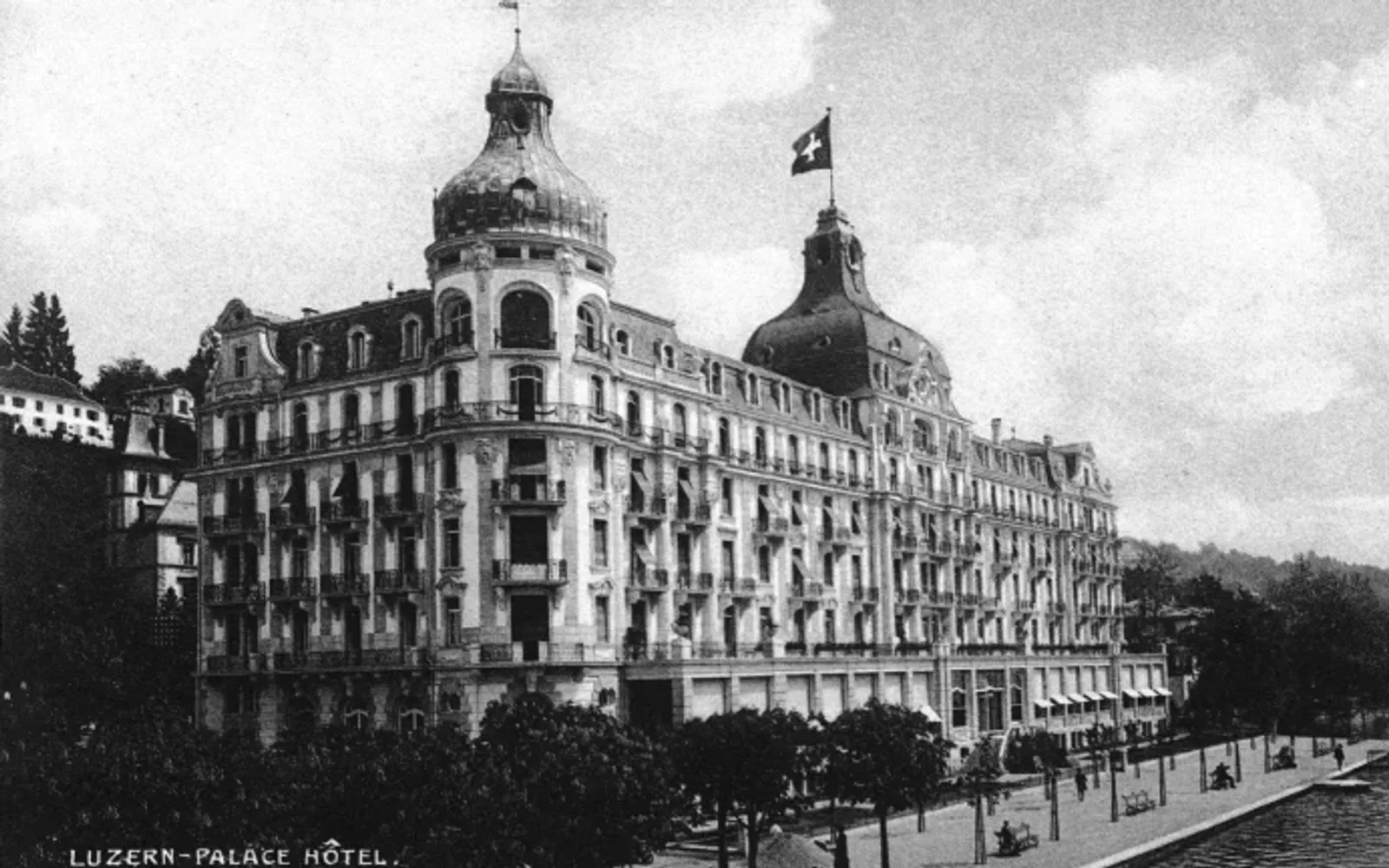 Historic black-and-white photograph of the Palace hotel in Lucerne, showing the grand lakeside façade in the early 1900s.