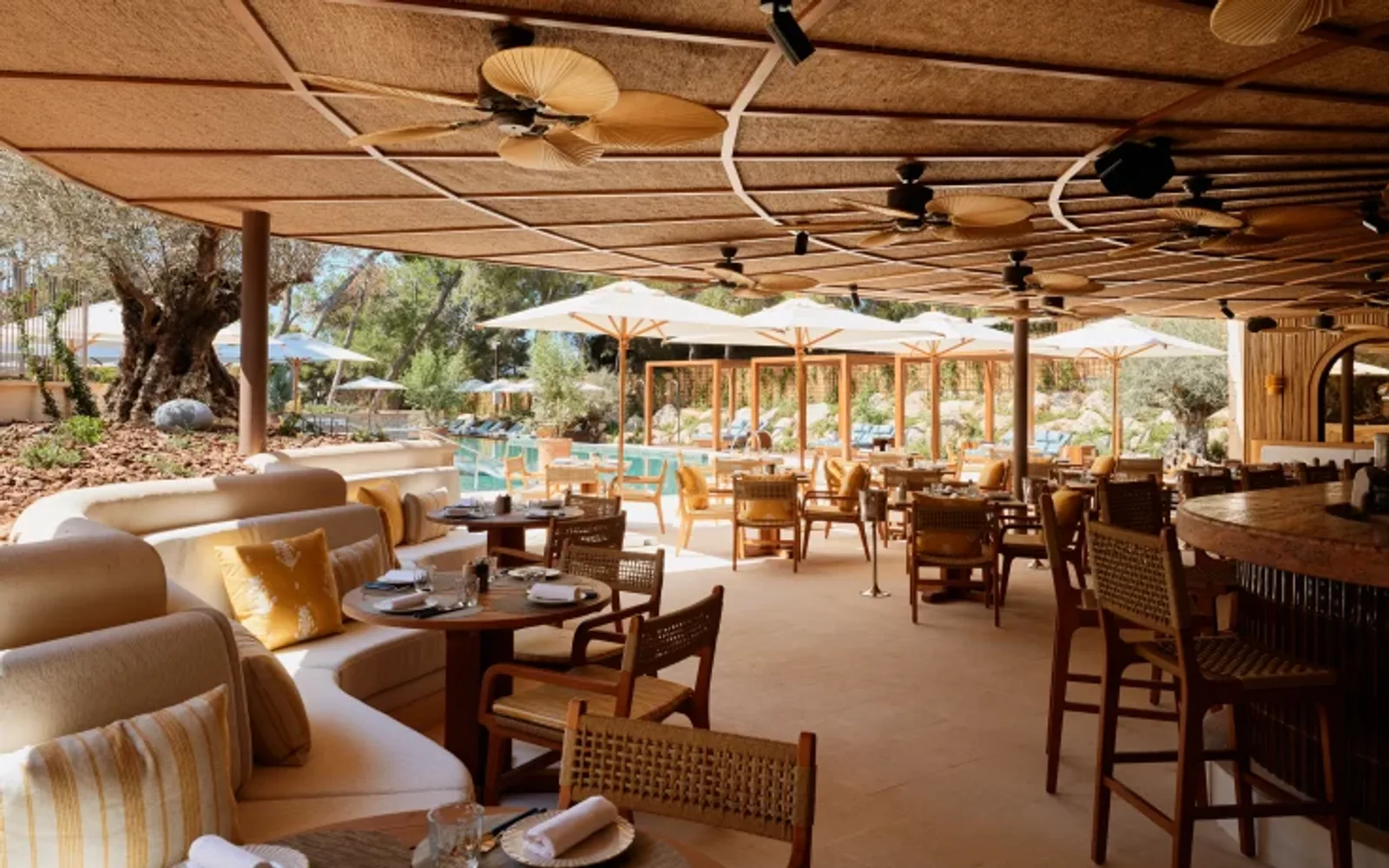 Outdoor terrace dining area with comfortable lounge seating and bar seating.