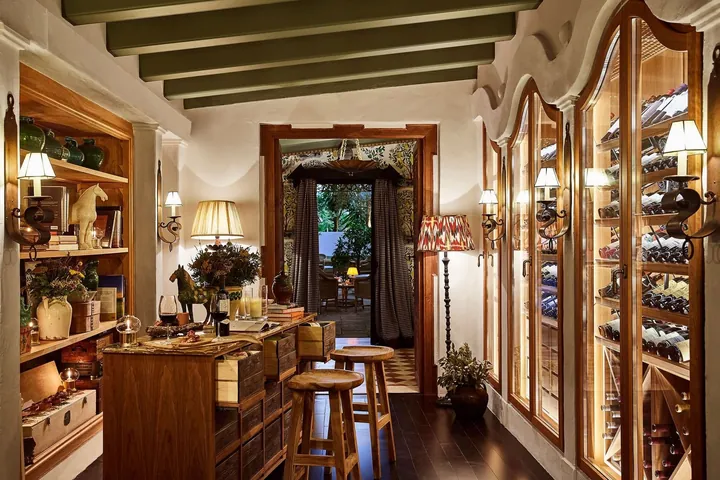 Wine displays and counter seating inside La Bodega at Marbella Club