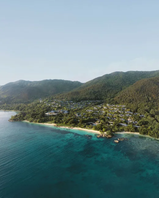 The coastline and hillside setting of Raffles Seychelles
