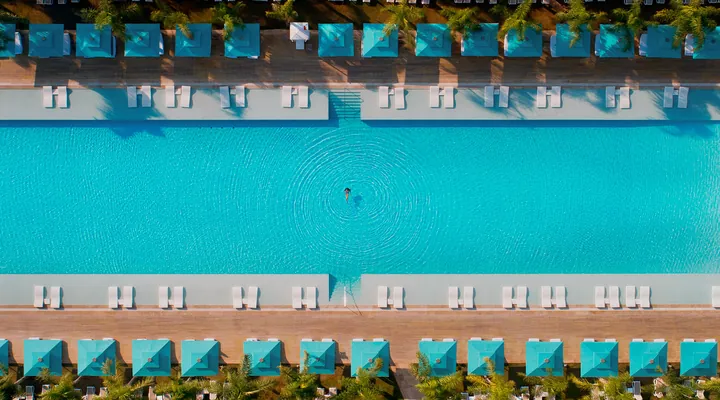 Aerial view of the main swimming pool and sun loungers at Regnum Carya