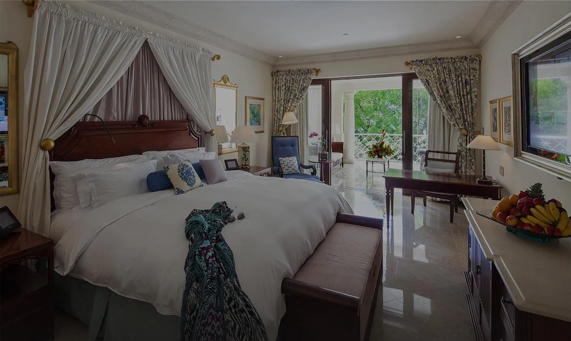 Guest room with a canopied bed and garden outlook at Sandy Lane, Barbados