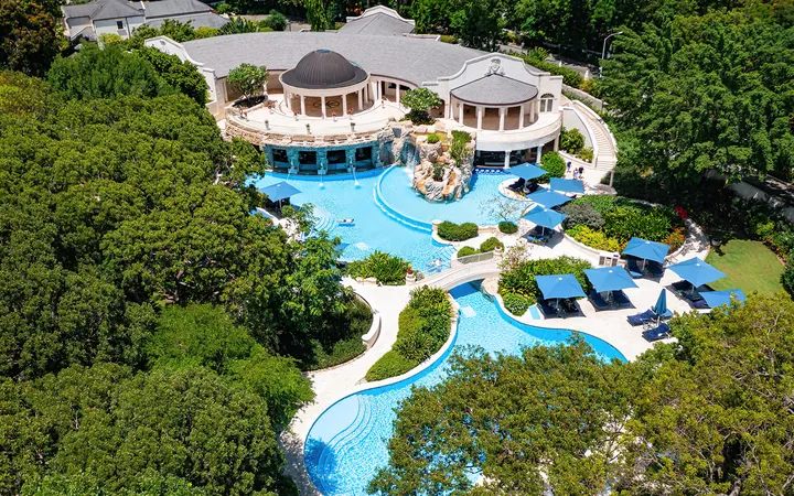 Swimming pool and sun terraces among the gardens at Sandy Lane, Barbados