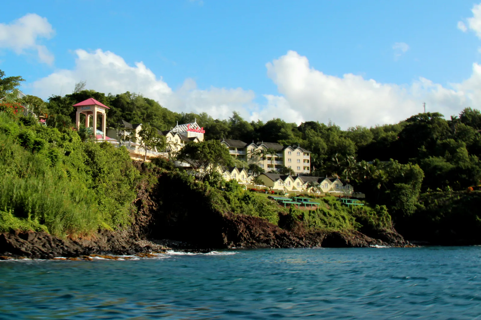 Sandals Regency La Toc across the green hillside above the Caribbean Sea